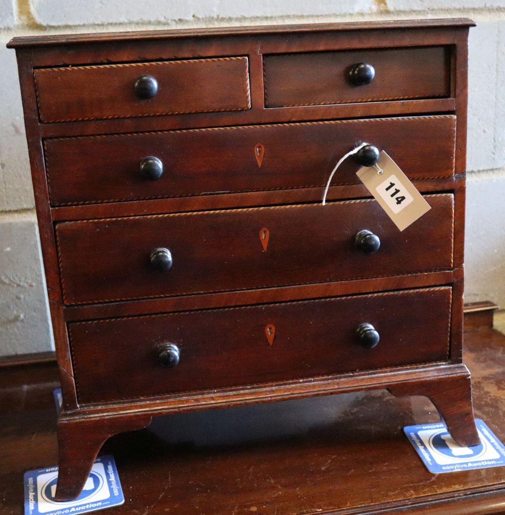 A George IV inlaid mahogany apprentice chest of drawers, width 42cm, depth 20cm, height 44cm